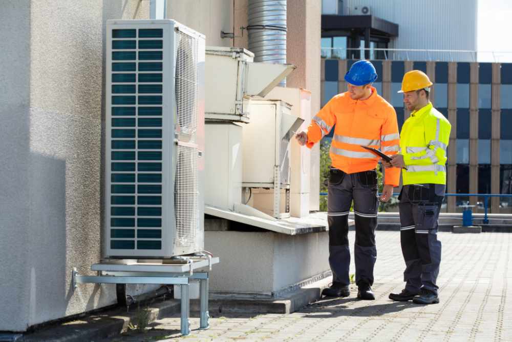 engineers inspecting and air conditioning system