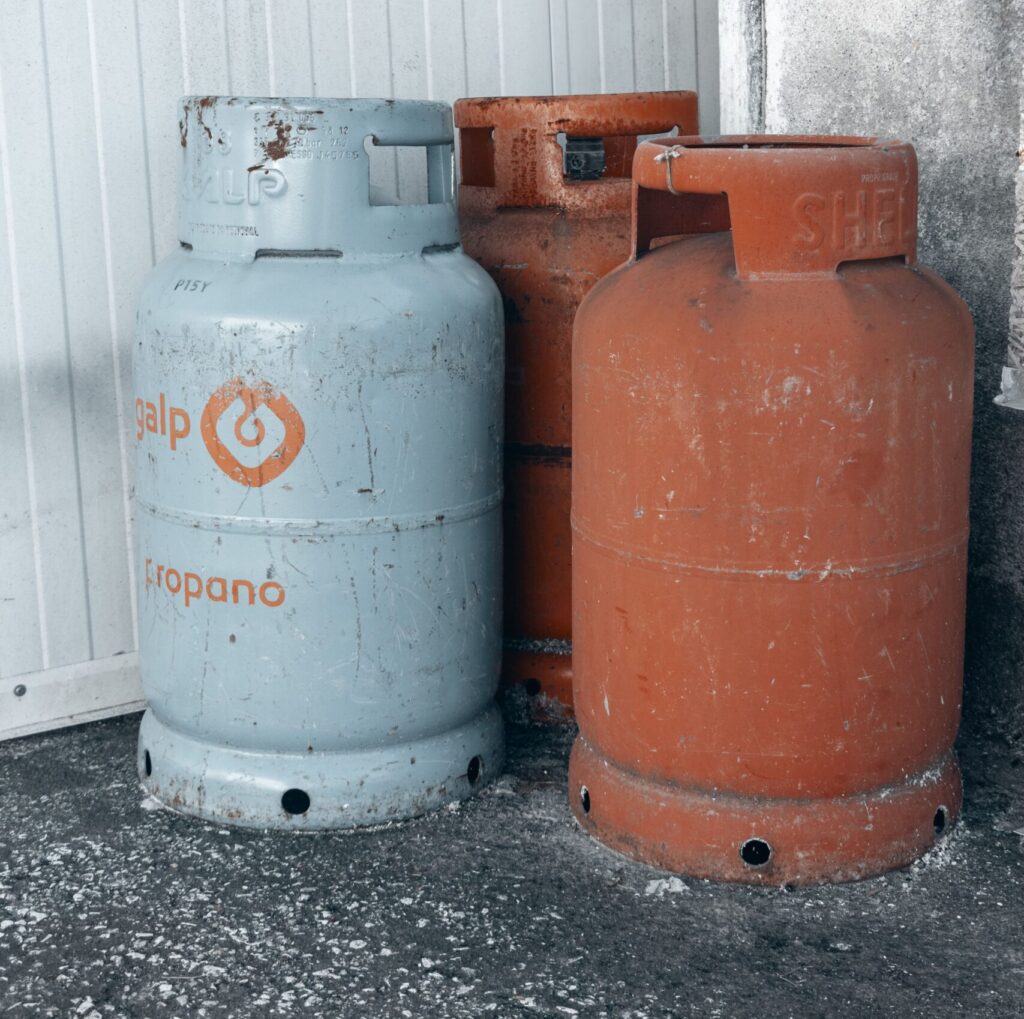 3 Gas Canisters against a wall